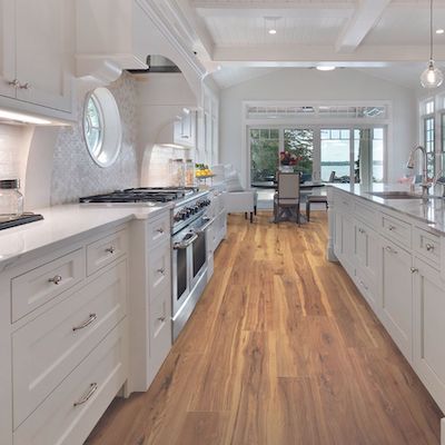 wood look laminate flooring in a bright white kitchen